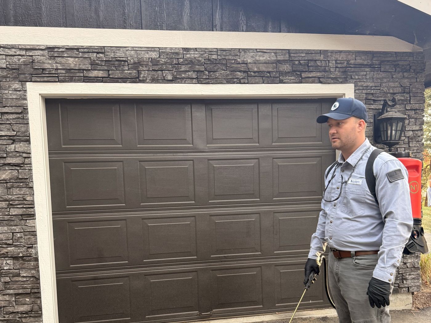 Lion Gate technician treating around a garage
